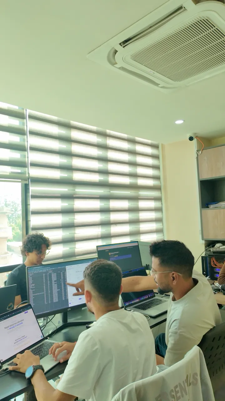NepalHRM engineering team reviewing product data on screen at their desks in the Kathmandu office