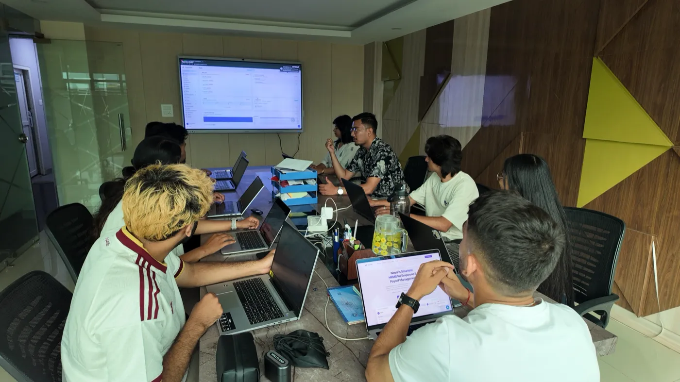 NepalHRM team in a product meeting reviewing the HRMS dashboard on screen at our Kathmandu office